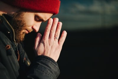Man praying outside 